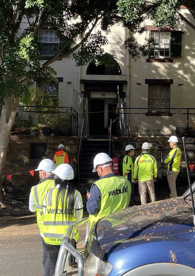 We Build Australia site team walking past the heritage façade at Ways Terrace, Pyrmont